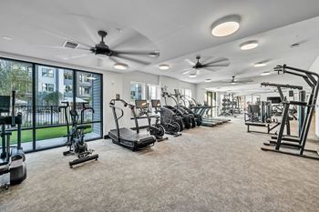 A spacious home gym with a variety of exercise equipment.